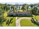 Lakefront property with a lush green lawn and a charming one-story home surrounded by beautiful palm trees at 9744 Cub Cv, Apopka, FL 32703