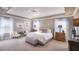 Serene bedroom with a tray ceiling, neutral colors, and ample natural light from large windows at Tbd Shirley Shores Rd, Tavares, FL 32778