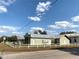 Charming one-story home with a new metal roof and a white picket fence at 100 John St, Frostproof, FL 33843
