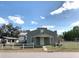 Neat one-story home with a metal roof and tidy landscaping at 100 John St, Frostproof, FL 33843