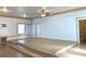 Tiled interior featuring a raised platform, neutral walls, and a ceiling fan at 100 John St, Frostproof, FL 33843