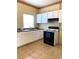 Bright kitchen features white cabinets, tile floors and modern appliances at 100 John St, Frostproof, FL 33843