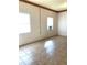 Empty room featuring neutral walls, tile floors, and two windows with AC at 100 John St, Frostproof, FL 33843