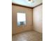 Small room featuring neutral walls, tile floors, and window with AC at 100 John St, Frostproof, FL 33843