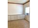 Bright room with white cabinets and a window AC unit at 100 John St, Frostproof, FL 33843