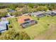 An aerial view of a beautiful house with a screened pool and lush green lawn at 10544 Spring Lake Dr, Clermont, FL 34711