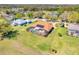Aerial view of a home featuring a large screened-in pool and solar panels at 10544 Spring Lake Dr, Clermont, FL 34711