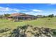 The backyard view shows a screened pool enclosure and manicured green lawn at 10544 Spring Lake Dr, Clermont, FL 34711