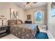 Cozy bedroom featuring bright window, ceiling fan, and elephant art piece at 10544 Spring Lake Dr, Clermont, FL 34711