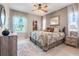 Bright bedroom with decorative ceiling fan, closet, and a picturesque window at 10544 Spring Lake Dr, Clermont, FL 34711