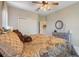 Cozy bedroom featuring a decorative ceiling fan, plush comforter and closet at 10544 Spring Lake Dr, Clermont, FL 34711