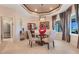 Bright dining room boasts elegant chandelier and ample natural light from large windows, creating an inviting atmosphere at 10544 Spring Lake Dr, Clermont, FL 34711