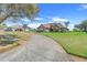 Beautifully landscaped home with a brick driveway and a well-manicured lawn at 10544 Spring Lake Dr, Clermont, FL 34711