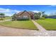 Beautifully landscaped home with a brick driveway and a well-manicured lawn at 10544 Spring Lake Dr, Clermont, FL 34711