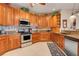 Gourmet kitchen features custom cabinetry, granite countertops, and stainless steel appliances at 10544 Spring Lake Dr, Clermont, FL 34711