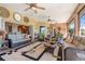 Spacious lanai features ample seating, a ceiling fan, and sliding glass doors that provide seamless indoor-outdoor living at 10544 Spring Lake Dr, Clermont, FL 34711