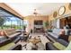 Relaxing lanai offers comfortable seating, a ceiling fan, and picturesque views of the surrounding landscape at 10544 Spring Lake Dr, Clermont, FL 34711