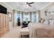 Light-filled main bedroom with tray ceiling, soft carpet, sitting area, and generous natural light at 10544 Spring Lake Dr, Clermont, FL 34711