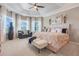 Spacious main bedroom with tray ceilings, plush seating area and abundant natural light at 10544 Spring Lake Dr, Clermont, FL 34711