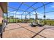 Enclosed patio features brick flooring, chaise lounges, and a beautiful view of the property at 10544 Spring Lake Dr, Clermont, FL 34711
