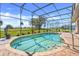 Refreshing screened-in pool with brick surround, perfect for enjoying sunny days and outdoor entertainment at 10544 Spring Lake Dr, Clermont, FL 34711