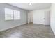 Bright bedroom with wood-look floors and two windows and closet at 10607 Allisheim Ave, Orlando, FL 32825