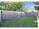 Fenced backyard with grass and trees at 107 Broadarrow Pl, Sanford, FL 32773