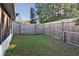 Fenced backyard with well-maintained lawn and mature trees at 107 Broadarrow Pl, Sanford, FL 32773