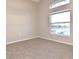Carpeted bedroom featuring an arched window offering natural light at 107 Broadarrow Pl, Sanford, FL 32773