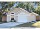 Charming single-story home featuring a two-car garage and a well-maintained front yard at 107 Broadarrow Pl, Sanford, FL 32773