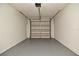 Spacious garage with gray sealed concrete floor, and white cinderblock walls at 107 Broadarrow Pl, Sanford, FL 32773