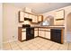 Kitchen boasting black appliances, white cabinets, and tiled flooring at 107 Broadarrow Pl, Sanford, FL 32773