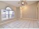 Spacious living room with a large window, ceiling fan, and neutral paint at 107 Broadarrow Pl, Sanford, FL 32773