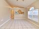 Bright living room featuring tile floors, and arched windows, creating an open and airy space at 107 Broadarrow Pl, Sanford, FL 32773