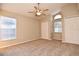 Inviting bedroom with plush carpeting, a ceiling fan, and natural light from the arched window at 107 Broadarrow Pl, Sanford, FL 32773