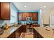 Well-lit kitchen with stainless steel appliances, granite countertops, and ample cabinet space at 10942 High Bush Ct, Orlando, FL 32825