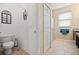 This light and airy bathroom features neutral colors and an ample doorway at 10942 High Bush Ct, Orlando, FL 32825