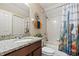 Bathroom with a granite vanity, neutral paint, and a decorative shower curtain at 10942 High Bush Ct, Orlando, FL 32825