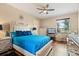 Bright bedroom features a plush bed, modern furnishings, and serene view from the window at 10942 High Bush Ct, Orlando, FL 32825
