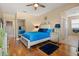 A well decorated main bedroom featuring wood floors, a bed, and neutral paint at 10942 High Bush Ct, Orlando, FL 32825
