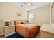 Cozy bedroom featuring warm tones, bedside tables, and a window offering natural light at 10942 High Bush Ct, Orlando, FL 32825