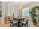 Bright dining room featuring modern light fixtures, decor, and a window at 10942 High Bush Ct, Orlando, FL 32825