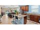 Kitchen overlooking living and dining area, featuring granite counters and stainless appliances at 10942 High Bush Ct, Orlando, FL 32825