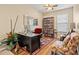 Well lit home office with decor, shelving, and a comfortable seating area at 10942 High Bush Ct, Orlando, FL 32825