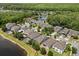 Wide aerial view showcases a residential area, highlighting the layout of homes around a pond at 10942 High Bush Ct, Orlando, FL 32825