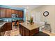 Modern kitchen featuring granite countertops, stainless steel appliances, and a functional island with seating at 10942 High Bush Ct, Orlando, FL 32825