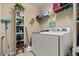 Bright laundry area featuring modern washer and dryer, storage shelving and essential laundry accessories at 10942 High Bush Ct, Orlando, FL 32825