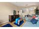 Comfortable living room with wood floors, neutral paint, entertainment center, and cozy seating at 10942 High Bush Ct, Orlando, FL 32825