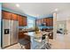 Charming kitchen featuring blue walls, stainless steel appliances, and granite countertops at 10942 High Bush Ct, Orlando, FL 32825