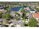 Aerial view of a residential neighborhood with a pond and lush greenery at 13643 Budworth Cir, Orlando, FL 32832